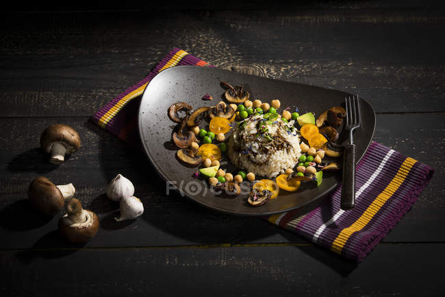 Vegan dish: natural rice with champignons, peas, chick peas, avocado and broccoli — Stock Photo