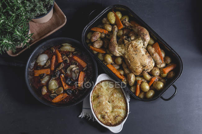 Chicken a la Coq au Vin with onion gratin, red vine sauce and baked potato — Stock Photo