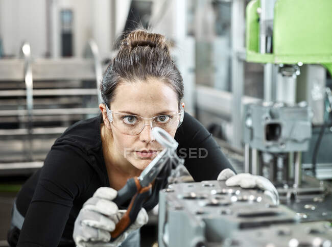 Young woman working with a pliers — Stock Photo