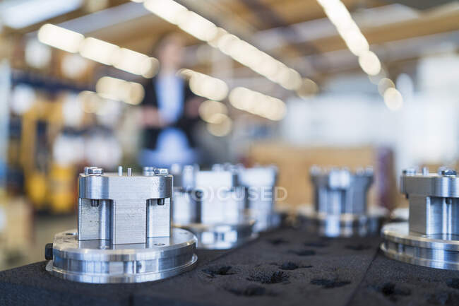 Products in a factory with person in background — Stock Photo