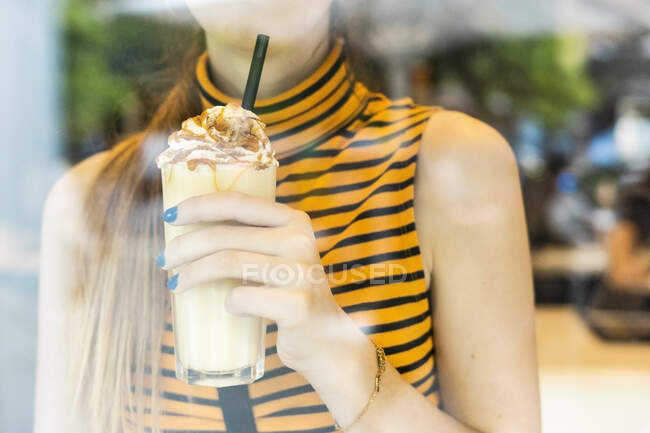 Close-up of teenage girl drinking a milk shake — Stock Photo
