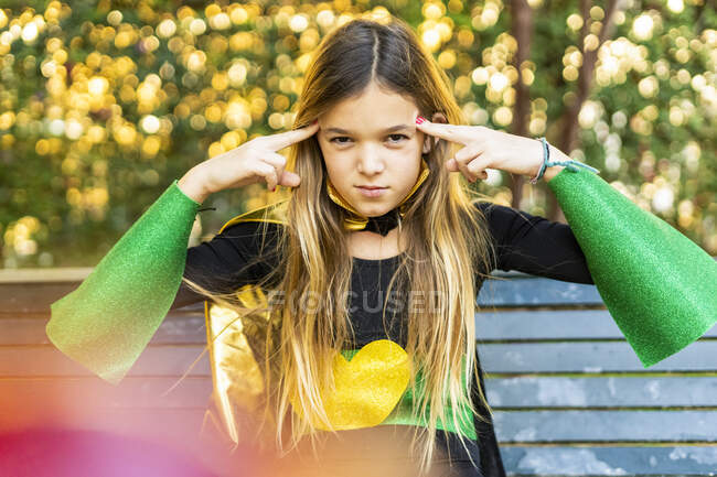 Girl posing in super heroine costume on a bench — strong, Elementary Age -  Stock Photo | #458048062
