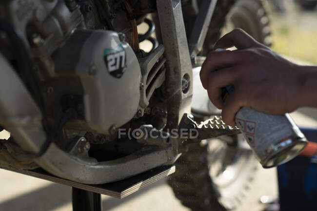 Close-up of man working on motocross bike — Stock Photo