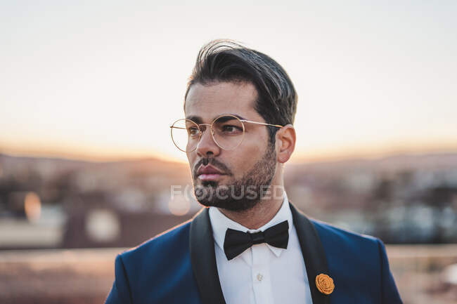 Portrait of stylish man on roof terrace at sunset — Stock Photo