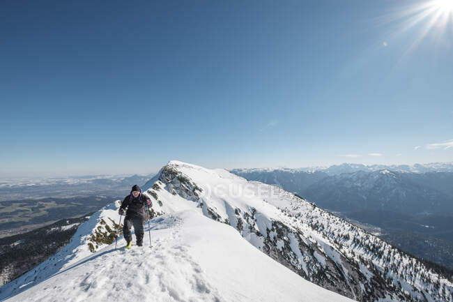 Germany, Bavaria, Gamsknogel, Weissbach, Chiemgau, senior man hiking in winter landscape — Stock Photo