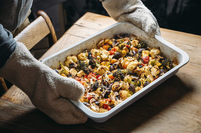Baked vegetables with feta cheese in a baking pan — Stock Photo