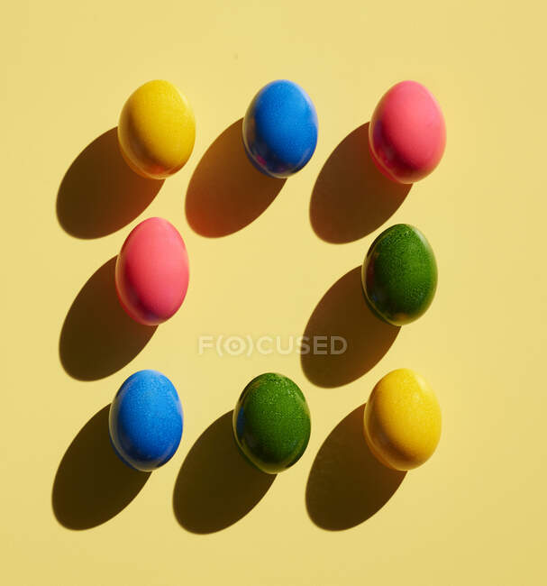 Huevos de Pascua teñidos sobre fondo amarillo - foto de stock
