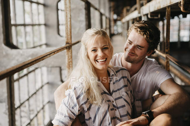 Portrait of happy young couple in an old building — Stock Photo