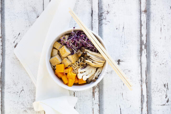 Miso Ramen soup with noodles, hokaido pumpkin, red radish sprouts, fried tofu, shimeji mushroom and king trumpet mushroom — Stock Photo