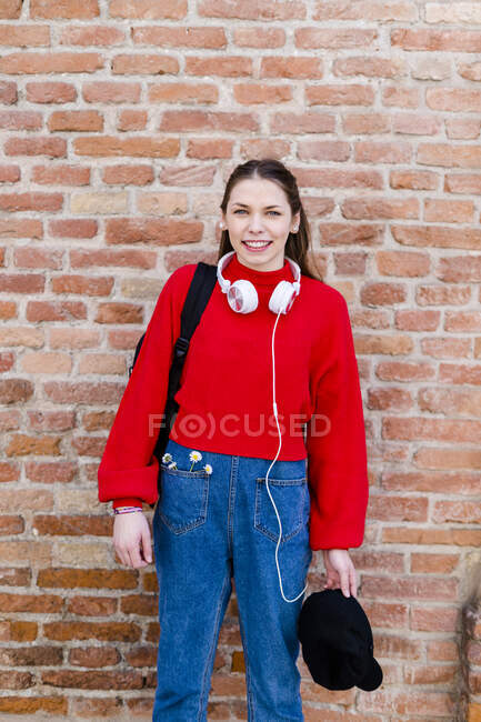Young woman wearing red pullover, headphones in Verona — Stock Photo