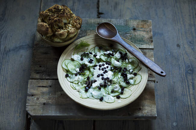 Ucumber salad with black beans, sheep cheese, dill and pickled bread — Stock Photo