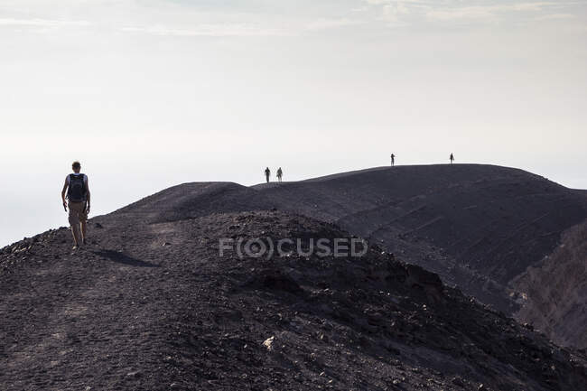 Aeolian Islands, Vulcano, Panoramic view from volcano, hikers at volcanic crater — Stock Photo