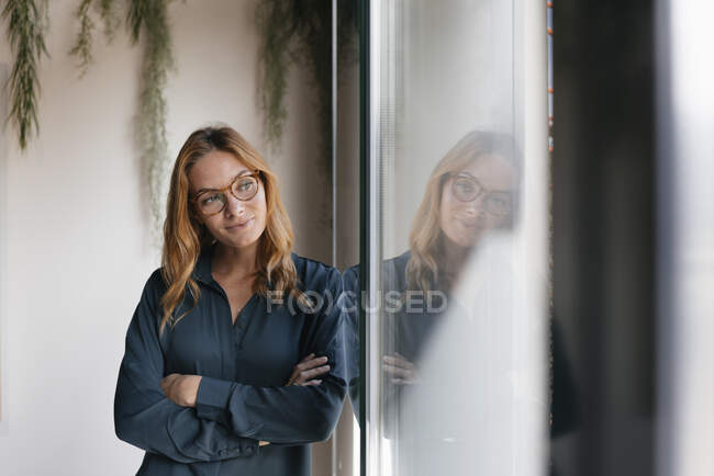 Empresária olhando pela janela — Fotografia de Stock