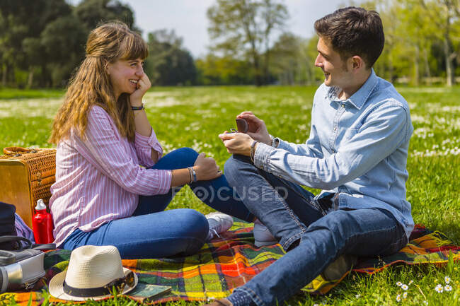 Giovane uomo che propone alla sua ragazza in un parco — Foto stock