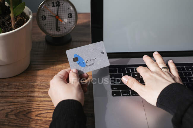 Woman using laptop and credit card for online shopping, partial view — Stock Photo