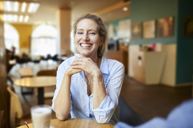 Portrait of happy woman in a cafe — Stock Photo