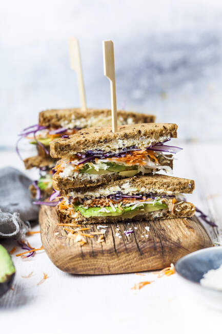 Veggie Sandwich, whole meal toast bread with grated carrot, red cabbage, white cabbage, avocado and cheese — Stock Photo