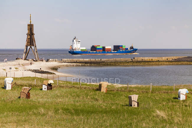 Germany, Lower Saxony, Cuxhaven, North Sea, Ball beacon at beach, hooded beach chairs, container ship — Stock Photo