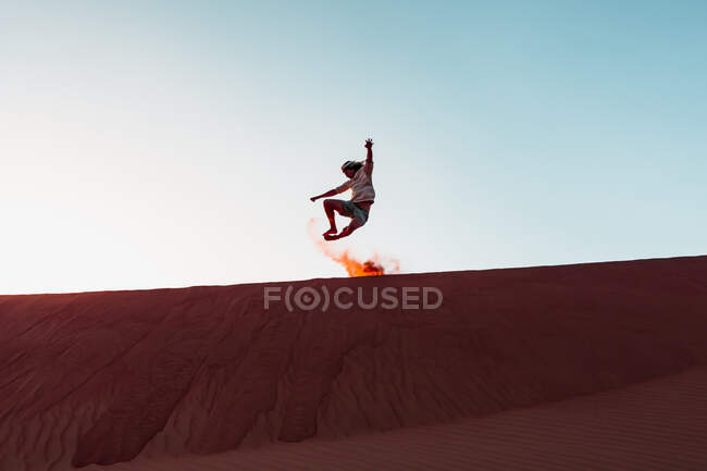 Султанат Оман, Вахіба Сендс, дорослий чоловік грає з піском у пустелі. — стокове фото