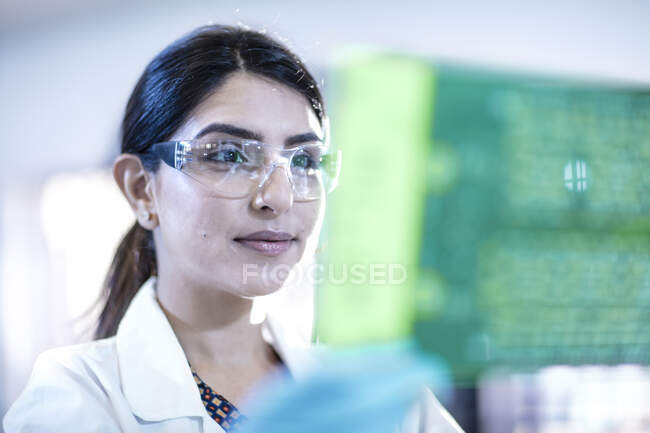 Female technician examining motherboard — Stock Photo