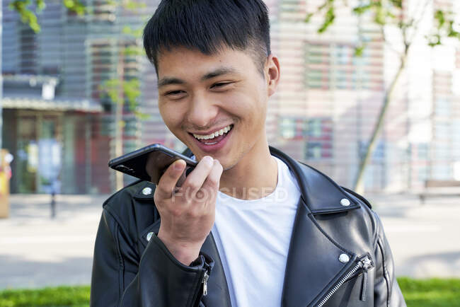 Happy young man sending a voice message with cell phone, Barcelone, Espagne — Photo de stock