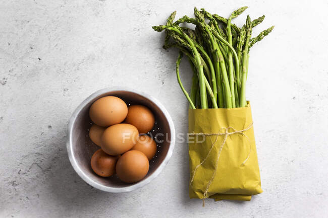Asparagus and eggs on table, close view — Stock Photo