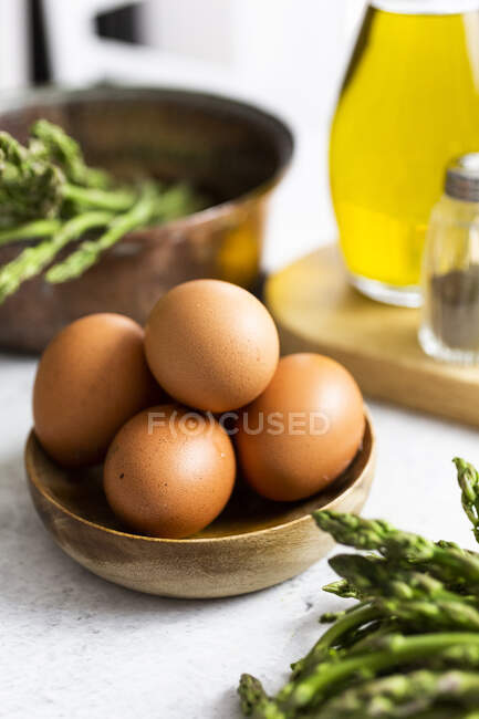 Asparagus and eggs on table, close view — Stock Photo