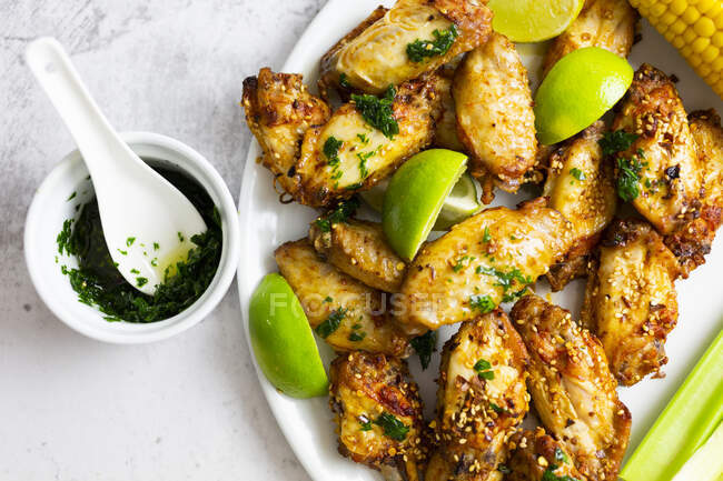 Ali di pollo piccanti con lime e sedano sul piatto — Foto stock
