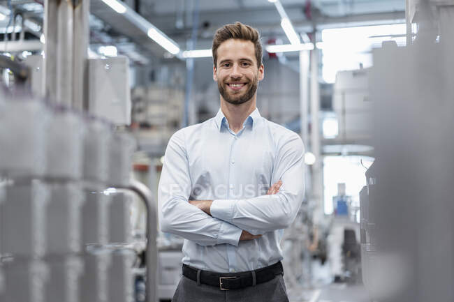 Portrait of a confident businessman in a modern factory — Stock Photo