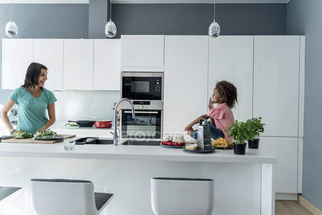 Happy mother and daughter cooking in kitchen together — Stock Photo