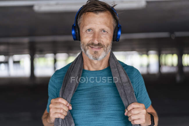Portrait of a sporty man wearing headphones after workout — Stock Photo