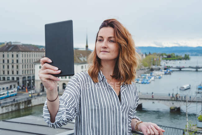 Young woman taking smartphone picture at Lake Zurich, Zurich, Switzerland — Stock Photo