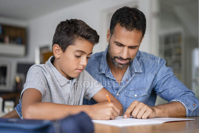 Батько допомагає синові робити домашнє завдання. — стокове фото