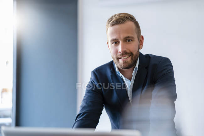 Portrait of smiling businessman in office — Stock Photo