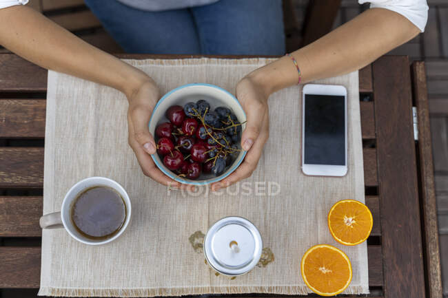 Top view of woman holding fruit bowl — Stock Photo