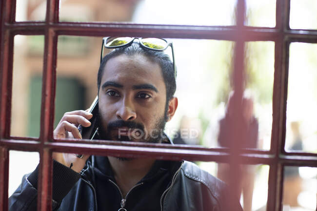 Portrait of bearded young man on the phone — Stock Photo