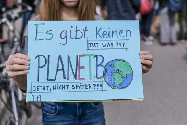 Girl holding a placard on a demonstration for environmentalism — Stock Photo