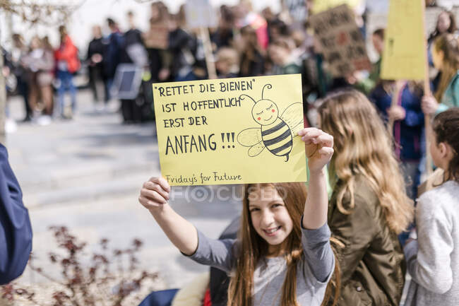 Girl holding a placard on a demonstration for environmentalism — Stock Photo