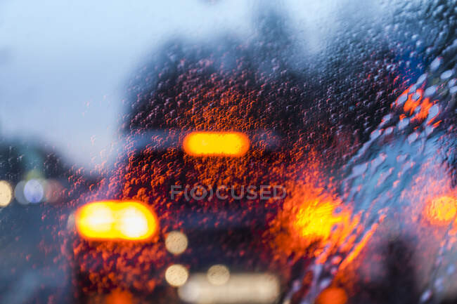 View through windscreen on rainy evening — Stock Photo