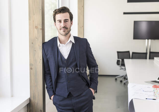 Confident businessman standing in boardroom — Stock Photo