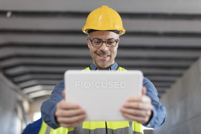 Architect using laptop at construction site — Stock Photo