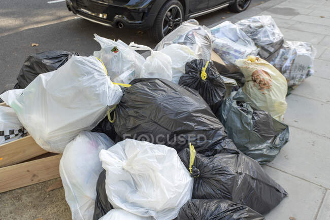 trash-bags-in-the-streets-of-london-uk-journey-litter-stock-photo