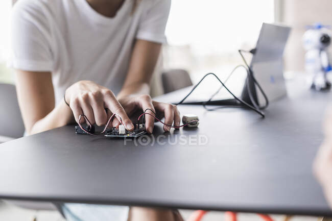 Close-up of woman working on computer equipment in office — Stock Photo