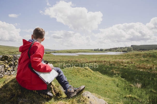 Boy with map looking at view, Cairngorms, Scotland, UK — Stock Photo