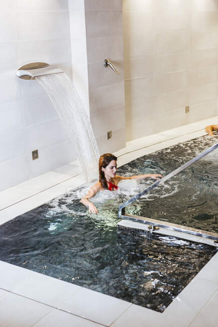 Woman enjoying the whirlpool in a spa — Stock Photo
