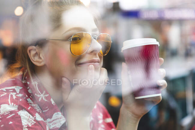 Молодая женщина в кафе пьет и пьет кофе — стоковое фото