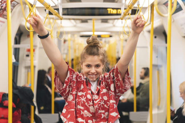 Portrait of happy young woman in the metro — Stock Photo