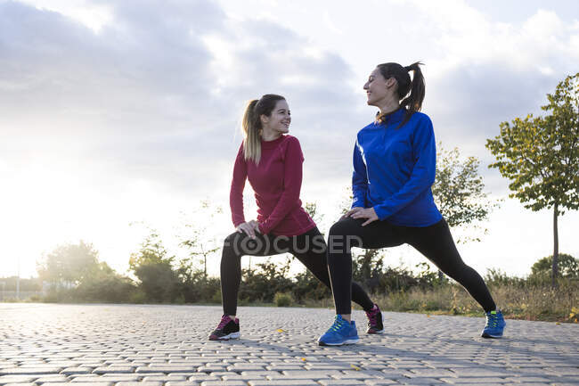 Women stretching her legs in the park — Stock Photo