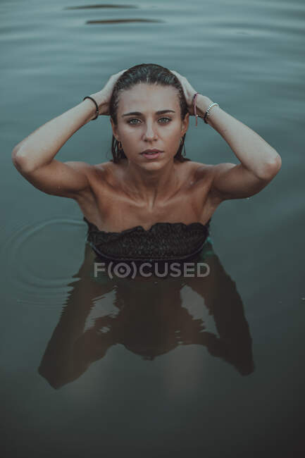 Portrait of young blond woman bathing in a lake — Stock Photo
