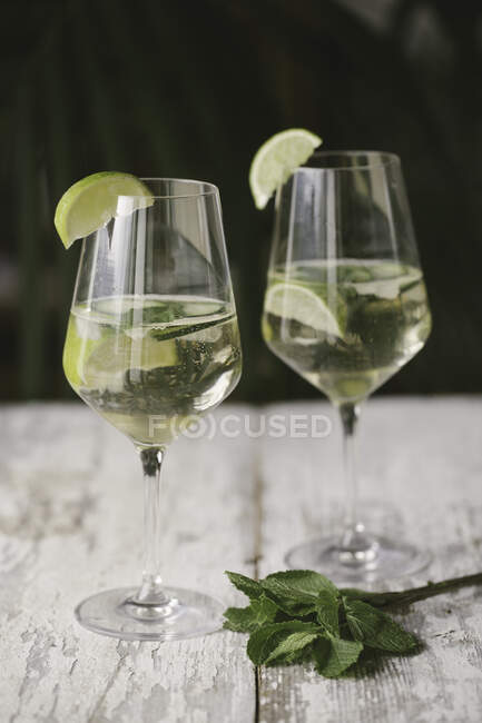 Close-up of cocktail with mint leaves on wooden table — Stock Photo
